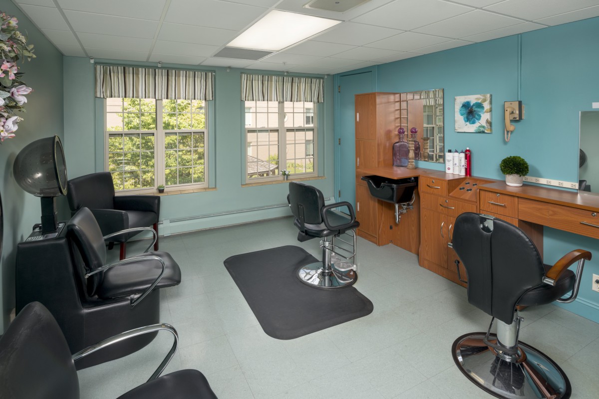 A cozy salon with styling chairs and mirrors.