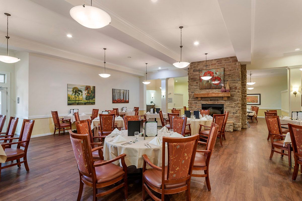 Elegant dining room with neatly arranged tables and a cozy fireplace.