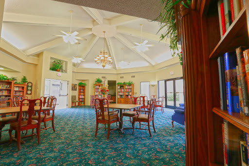 A spacious and well-lit lobby featuring elegant furniture and a decorative chandelier.