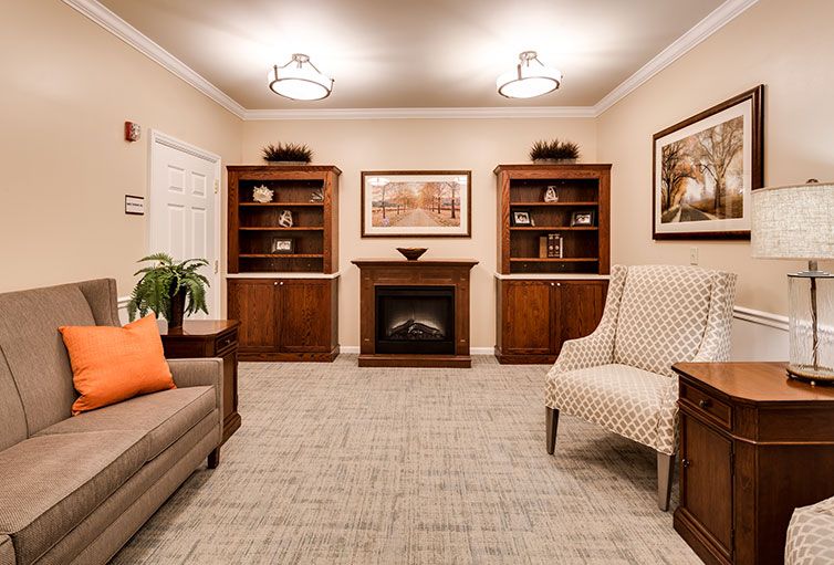 A cozy living room with elegant furniture and a warm fireplace.