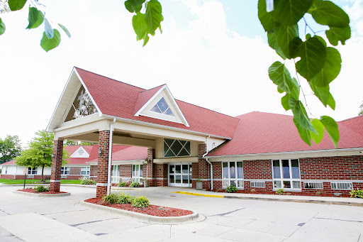 A welcoming exterior view of a building with a distinct red roof and modern architectural design.