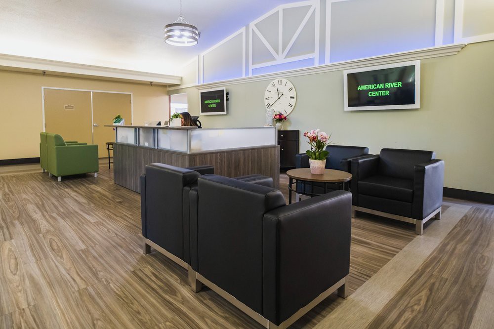 A modern lobby with comfortable seating and a reception desk.