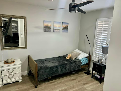 A cozy minimalist bedroom featuring a single bed, stylish decor, and plenty of natural light.