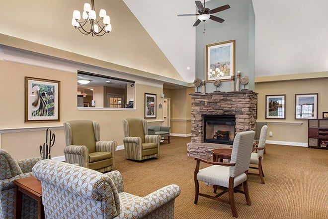 A cozy living area with armchairs, a fireplace, and elegant lighting.