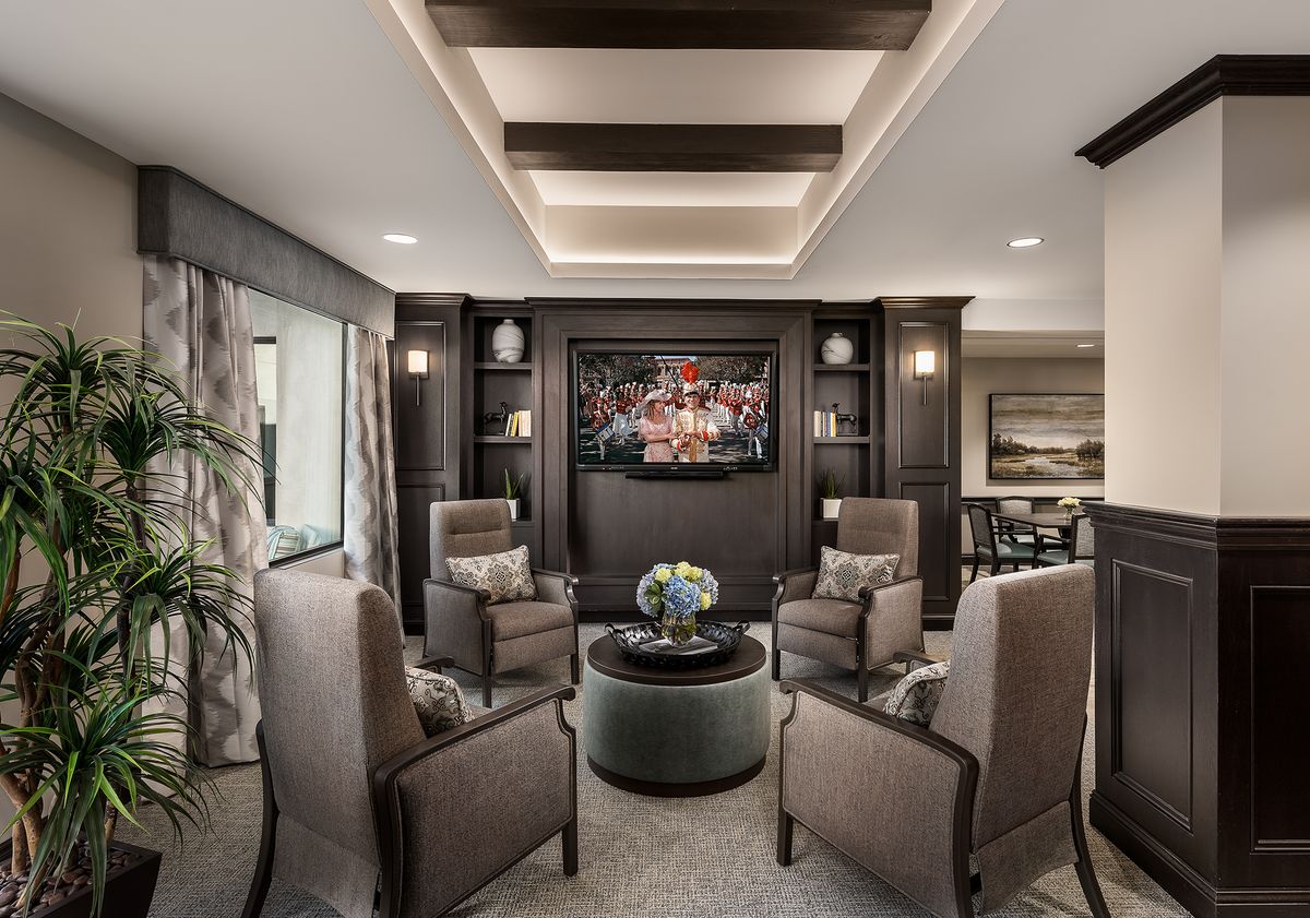 A modern living room with stylish seating arrangement and elegant artwork.