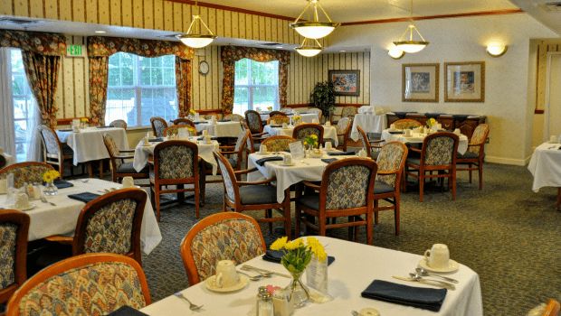 An elegant dining room with neatly arranged tables and chairs.