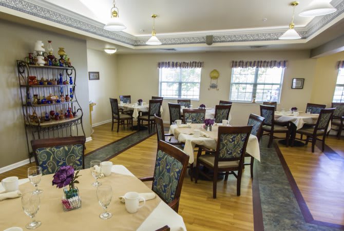 An elegantly arranged dining room with neatly set tables and chairs, ready for guests.