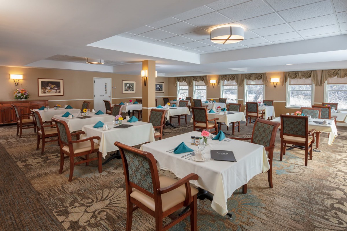 A well-appointed dining room with neatly arranged tables and elegant decor.