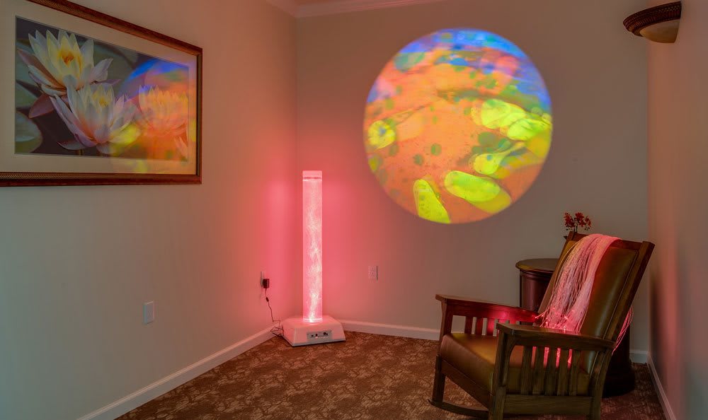 A sensory room featuring colorful projection lights and relaxation equipment.