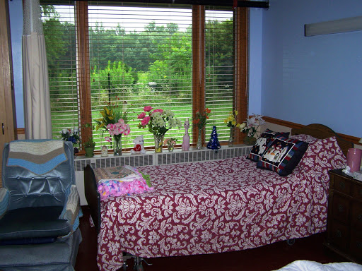 A cozy bedroom with a beautiful view of the nature outside.