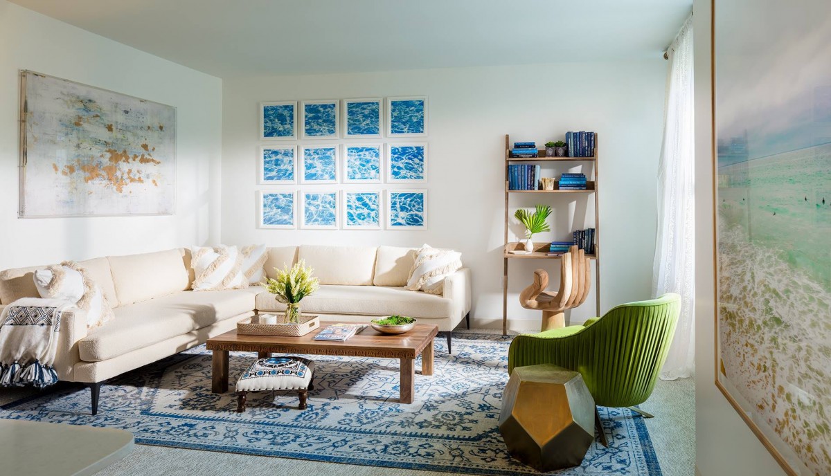 A stylish living room with a cozy sofa, colorful wall art, and modern furniture.