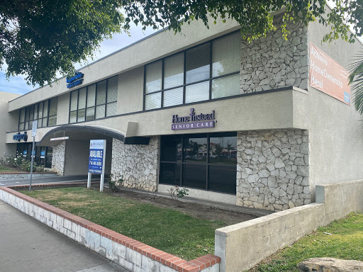 An exterior view of a restaurant building, showcasing its stone facade and large windows.