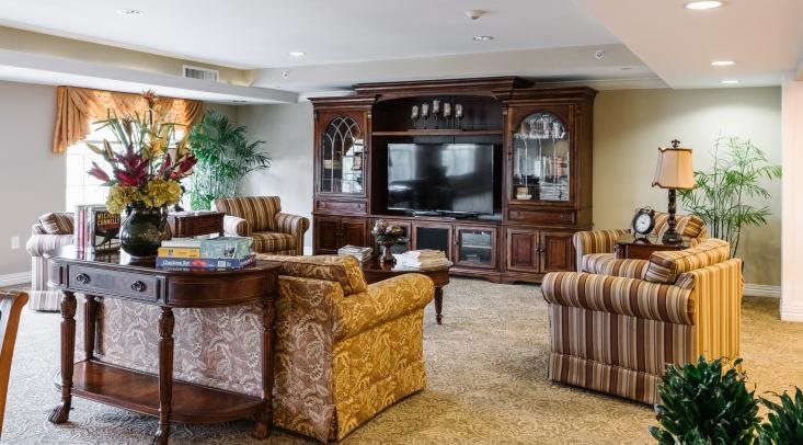 A cozy living room featuring an entertainment center with a large television and comfortable seating.