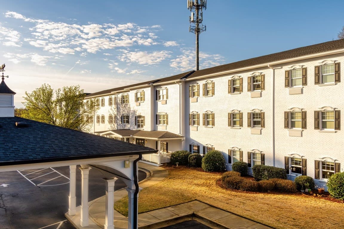 A view of a three-story hotel building during a sunny day.