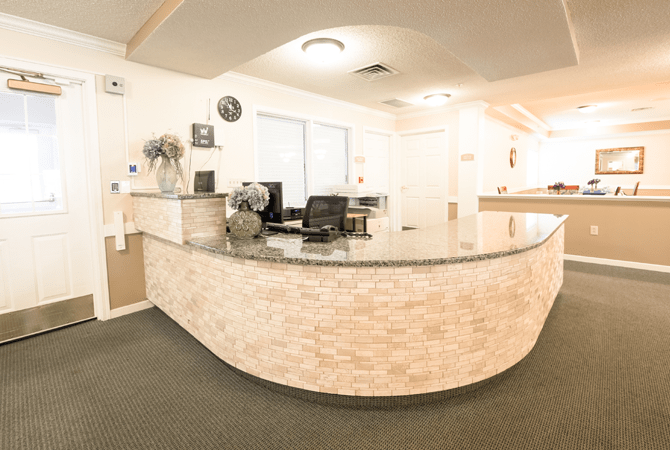 A modern reception area with a curved desk and office equipment.