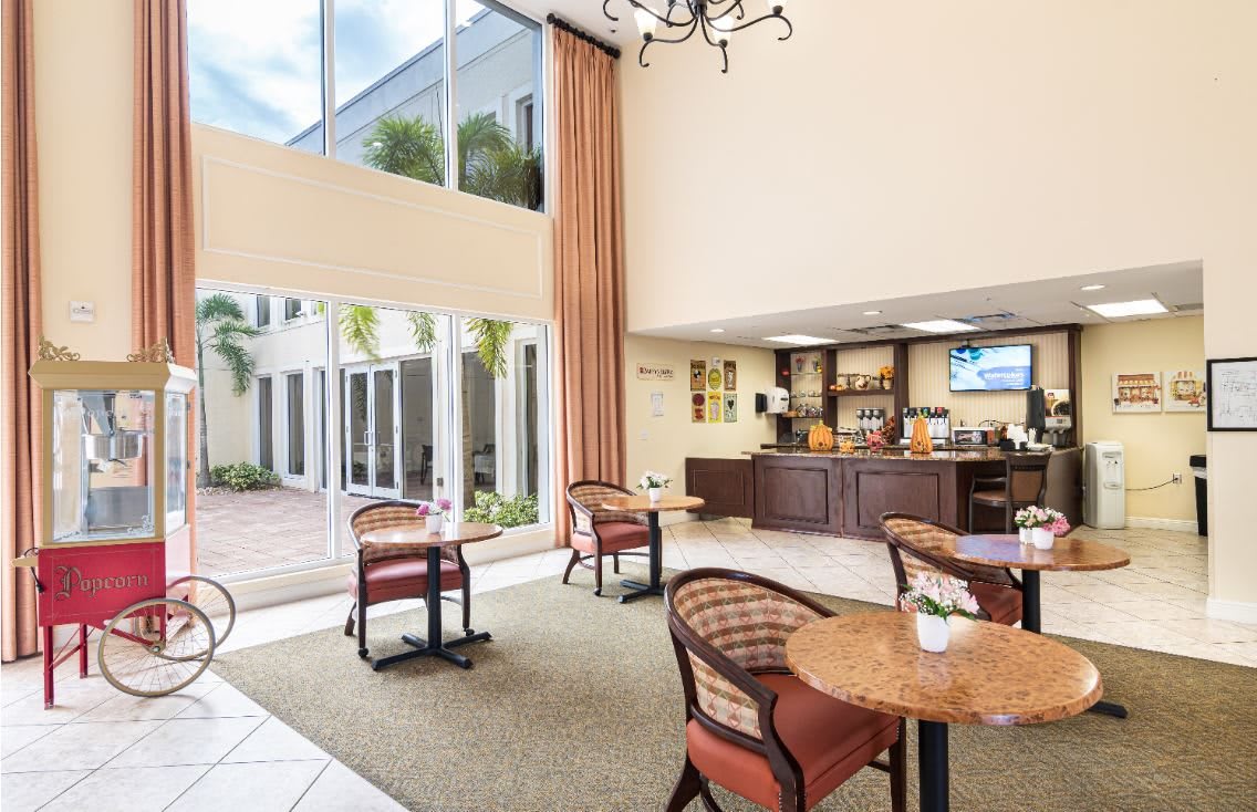 A bright and spacious lobby with a cozy seating area and large windows.