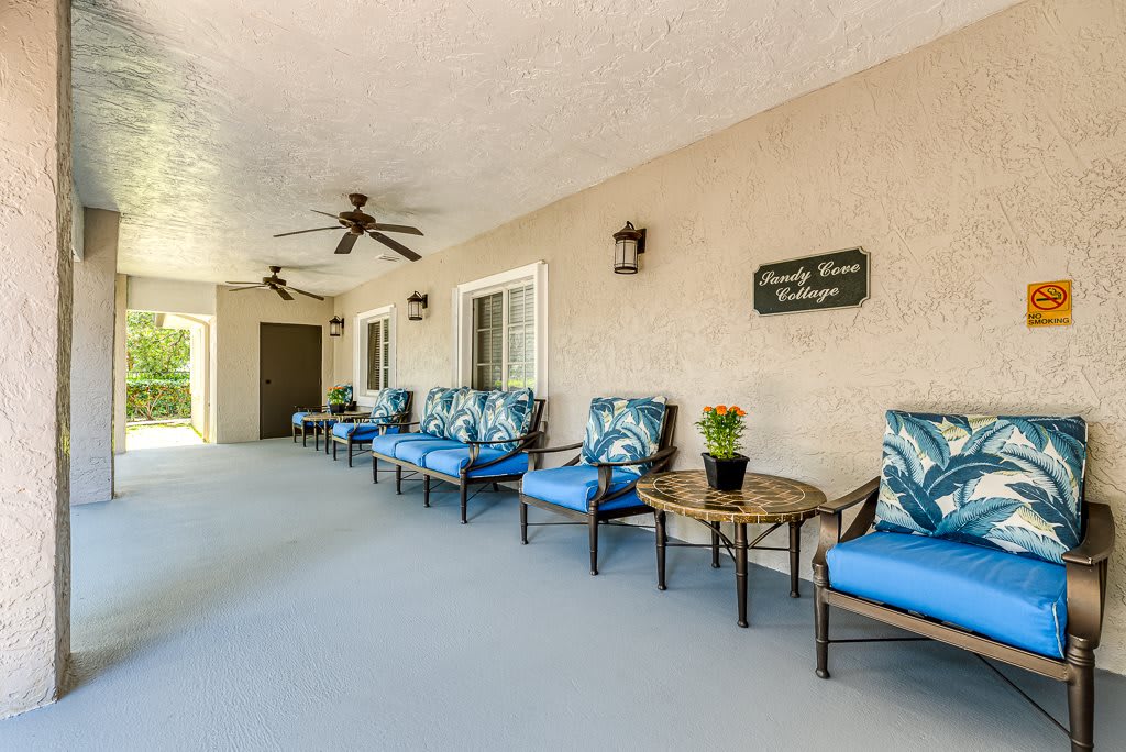 A well-furnished outdoor patio area with comfortable seating and decorative plants.