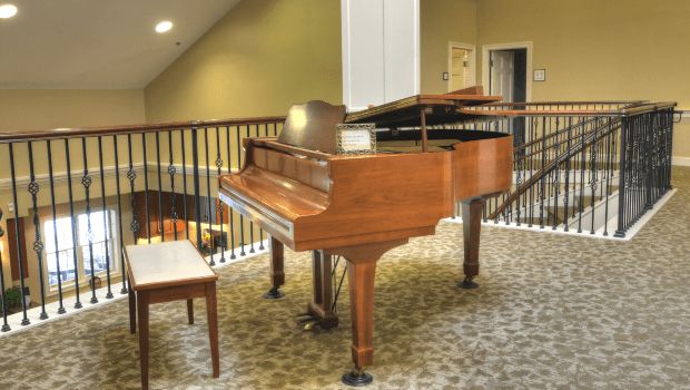 A grand piano with a matching bench in an elegantly designed interior space.