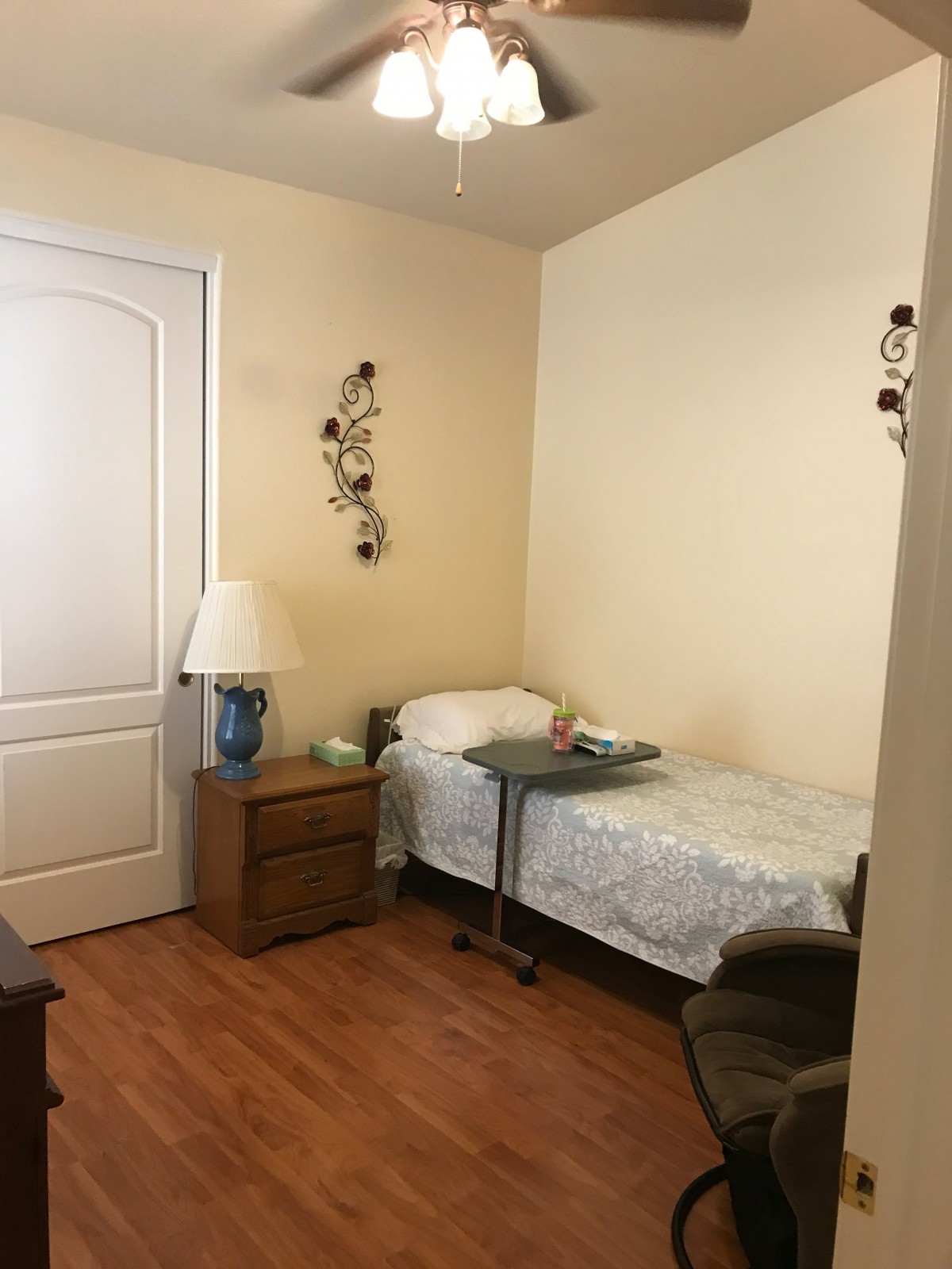 A small, neatly arranged bedroom with a single bed and simple decor.