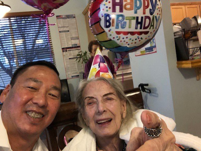 A joyful birthday celebration with balloons and party hats.