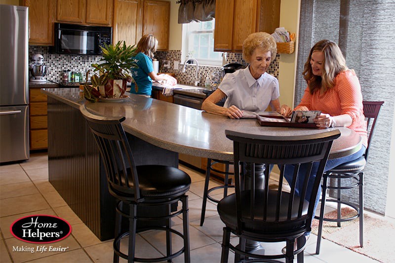 Family gathered in a kitchen, engaging in cooking and conversation.