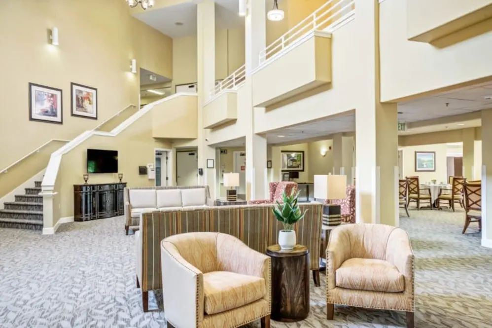 A spacious and bright hotel lobby featuring modern seating arrangements.