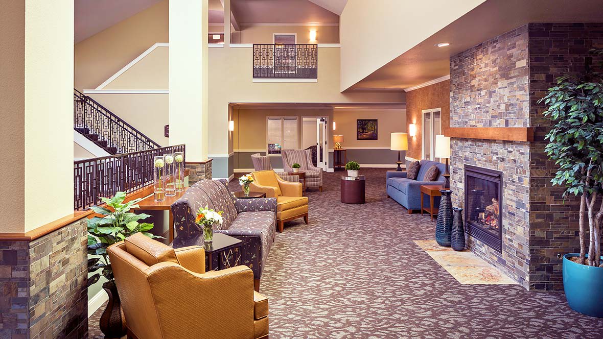 A cozy hotel lobby with comfortable seating and warm decor.