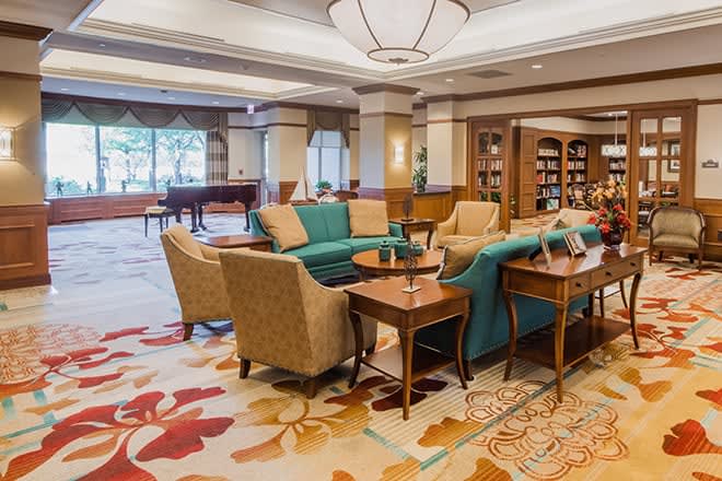 A cozy hotel lobby with comfortable seating and a small library.