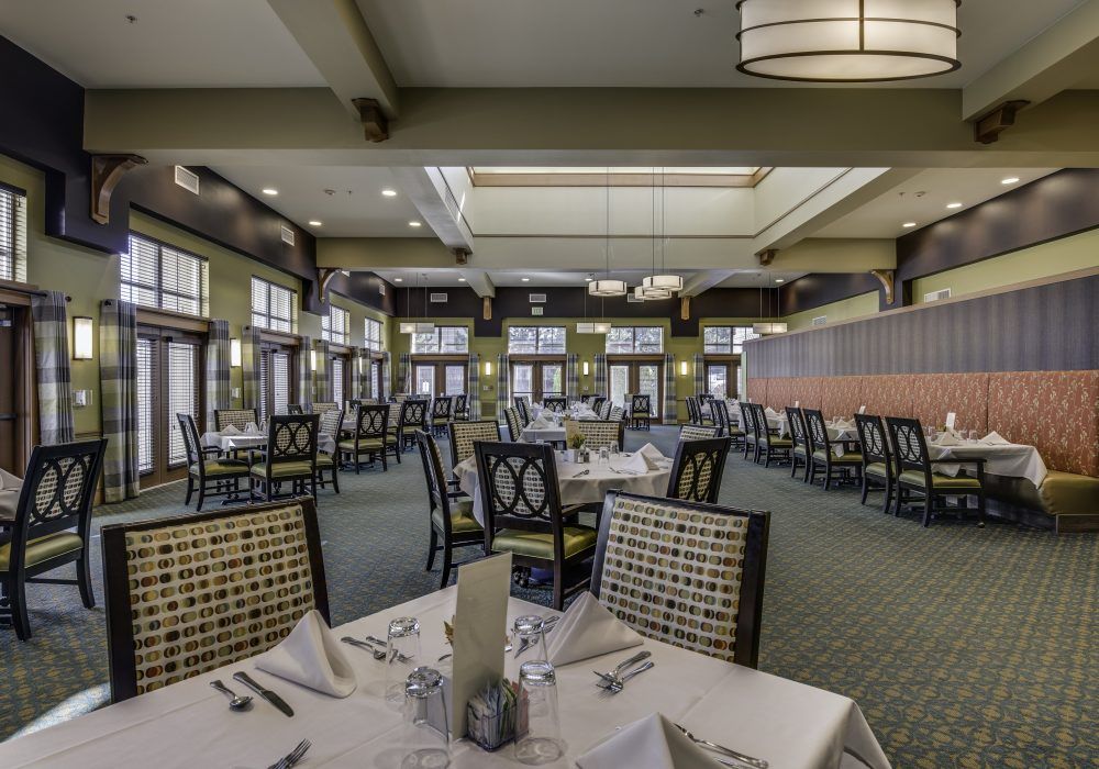 An elegant restaurant interior with neatly arranged tables and chairs, ready for dining.