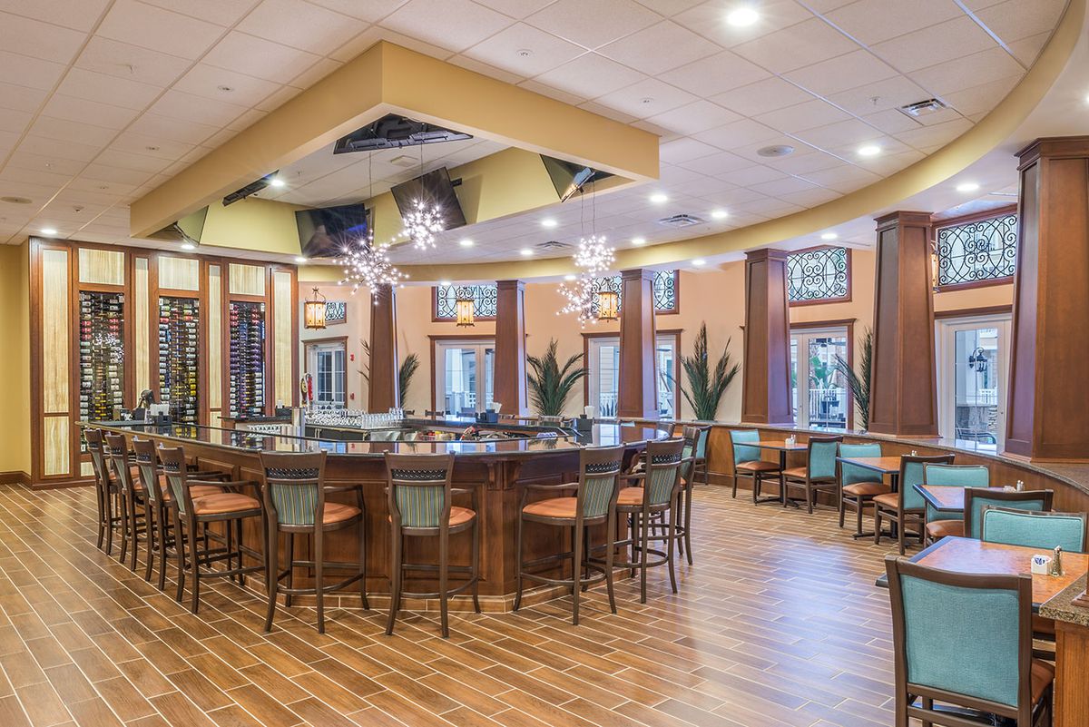 A modern bar interior with a circular seating arrangement and elegant decor.