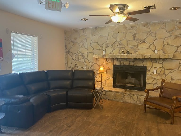 Cozy living room with a stone fireplace and sectional sofa.