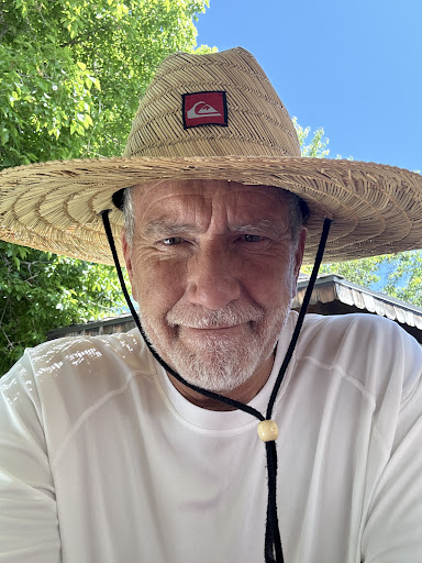 Enjoying a sunny day outdoors with a stylish straw hat.