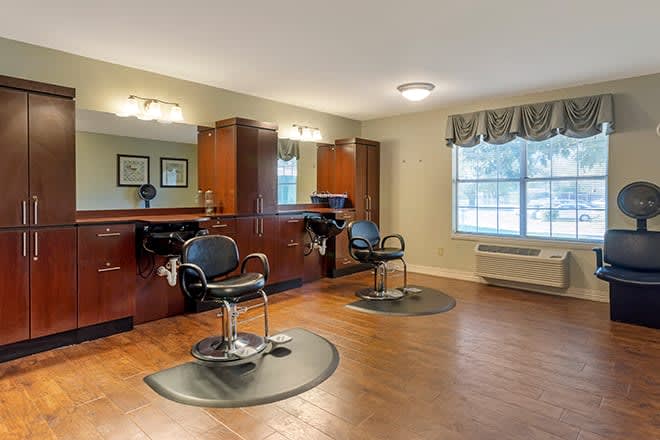 A modern hair salon interior with styling chairs and mirrors.