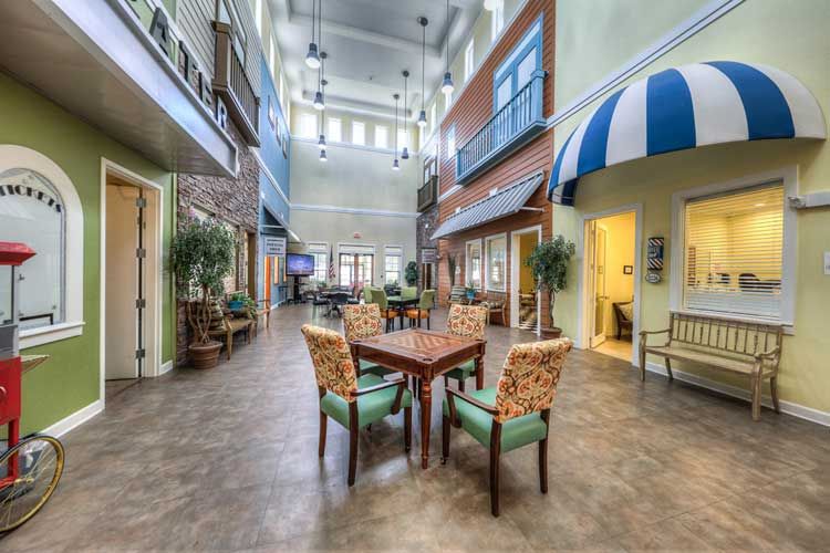 A spacious indoor communal area with seating arrangements and decorative lighting.