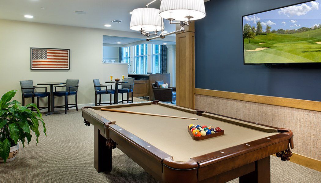 A well-designed recreation room featuring a pool table and seating area.