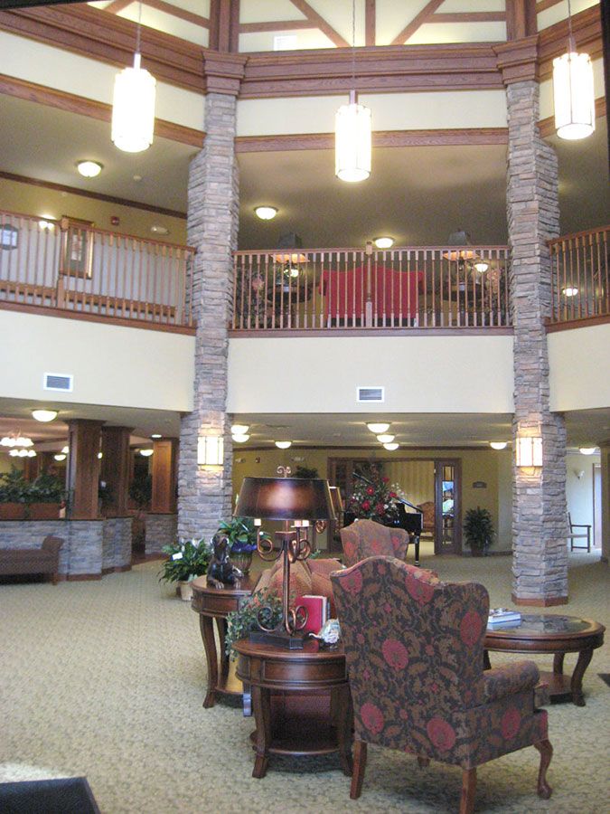 A spacious hotel lobby featuring comfortable seating and elegant lighting fixtures.