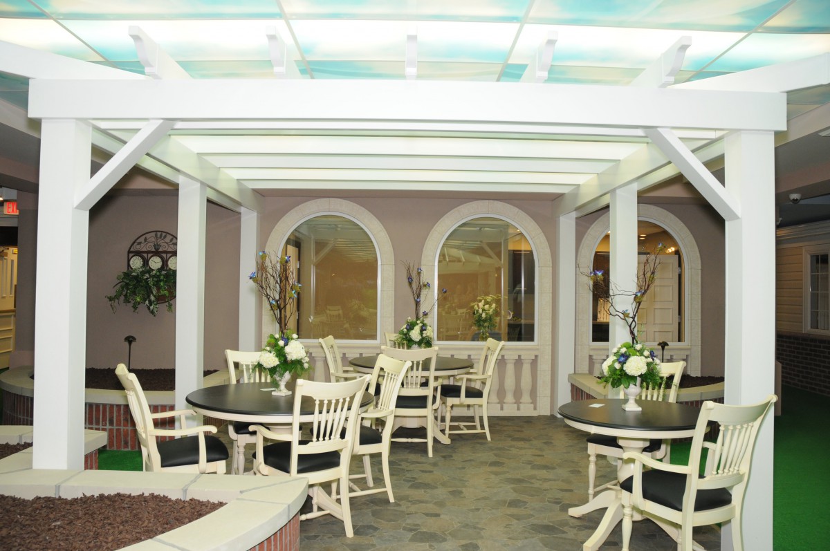 A cozy restaurant interior with neatly arranged tables and elegant floral decorations.