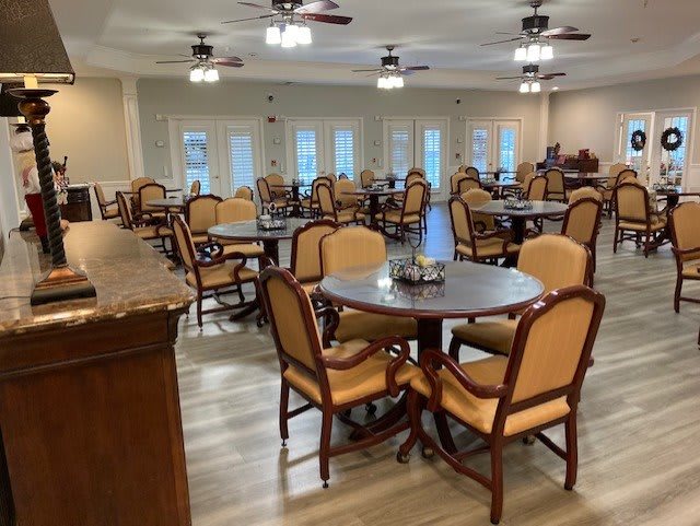 An empty restaurant dining area with neatly arranged tables and chairs.