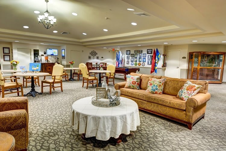 A cozy living room with a sofa, round table, and elegant decor.