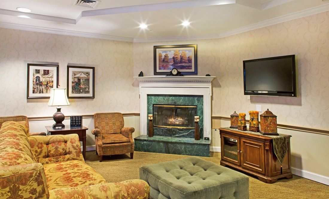 A cozy living room featuring a fireplace, comfortable seating, and elegant decor.