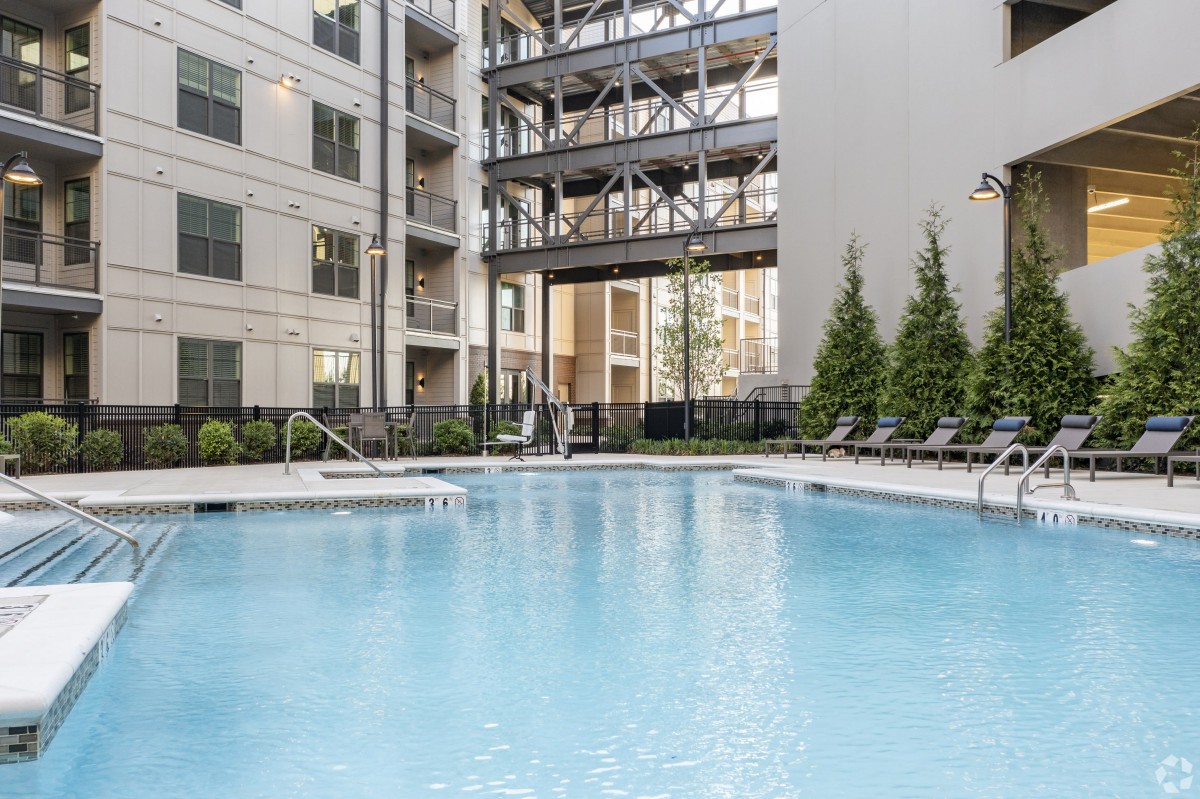 Outdoor pool area in a modern apartment complex.