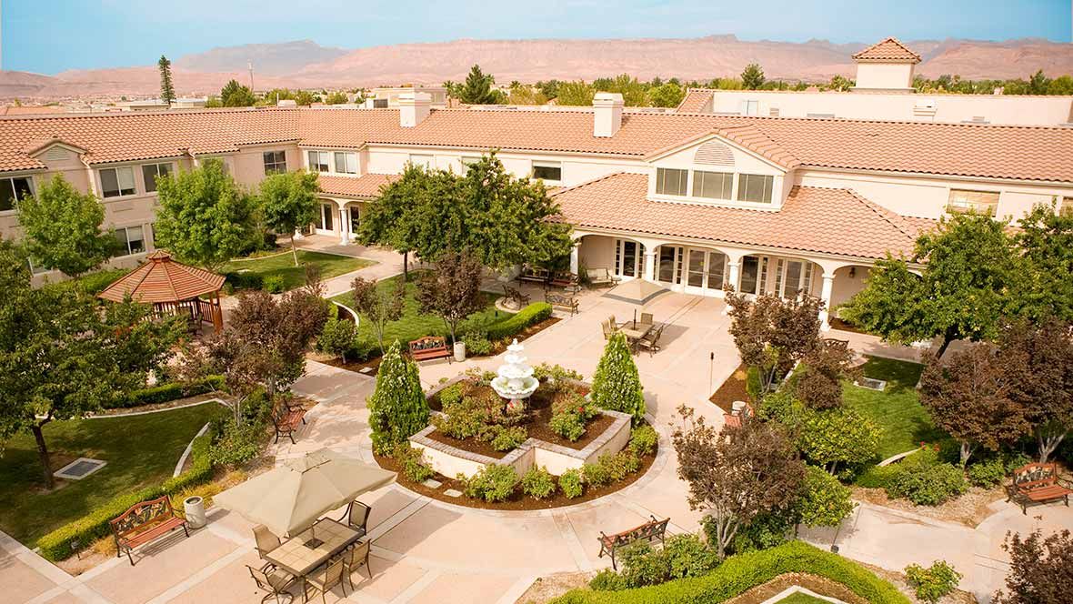 A beautifully landscaped courtyard with a central fountain and seating areas.