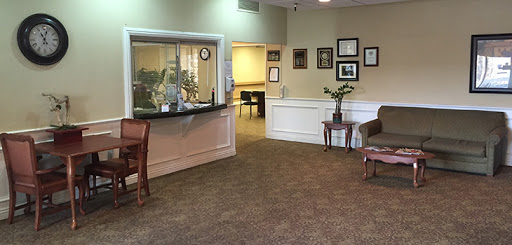 A cozy reception area featuring a welcoming atmosphere with comfortable seating and decorative elements.