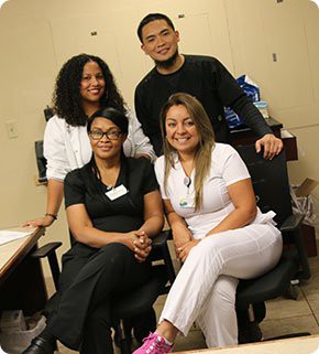A group of colleagues posing for a picture in an office setting.