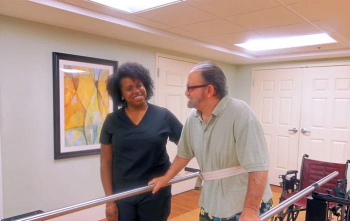 A therapist assists a patient during a rehabilitation session.