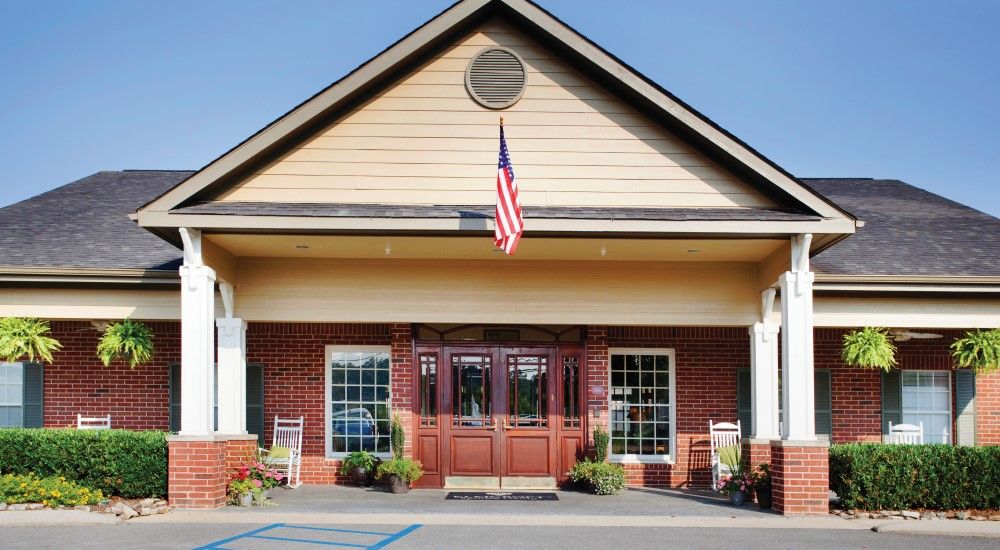 A building entrance with an American flag displayed above the door.