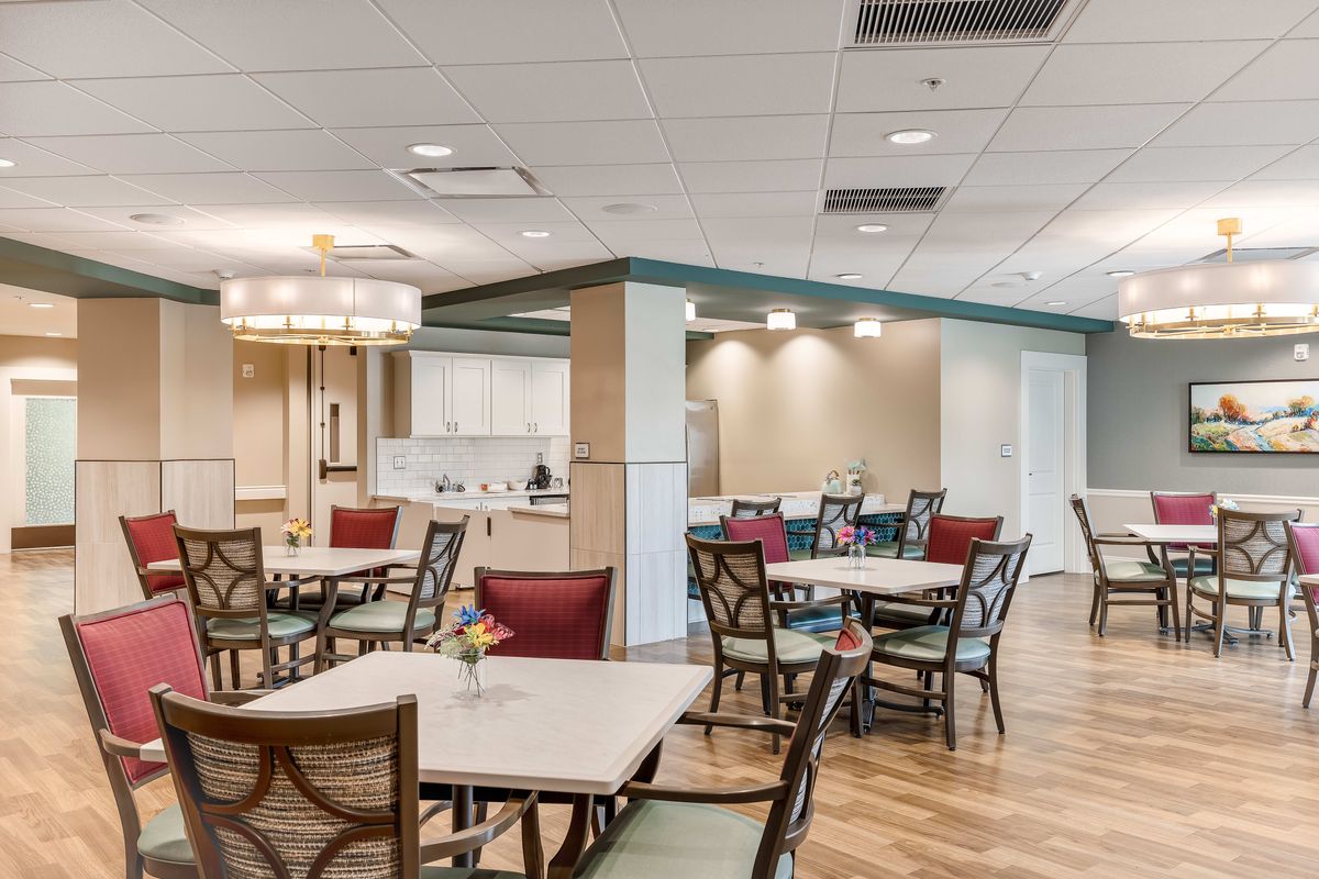A modern dining area with neatly arranged tables and chairs.