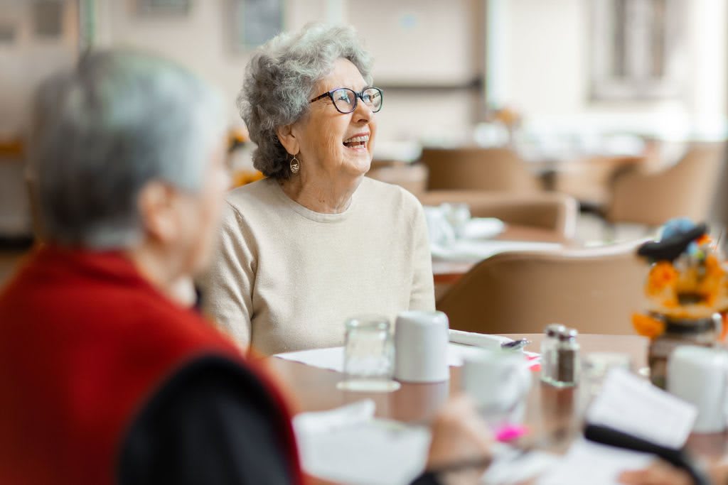 Elderly individuals enjoying social time at a restaurant.