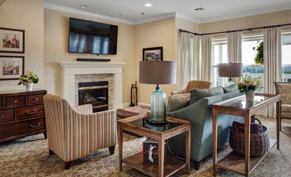 A cozy living room featuring a fireplace, sofa, and television.