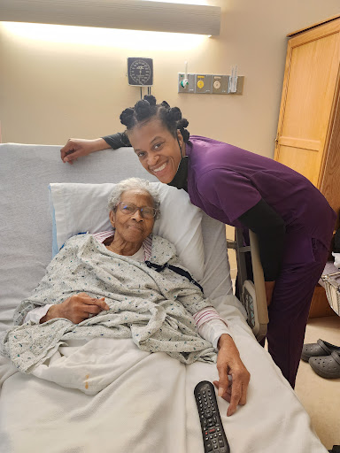 A touching moment between a nurse and an elderly patient in a hospital setting.